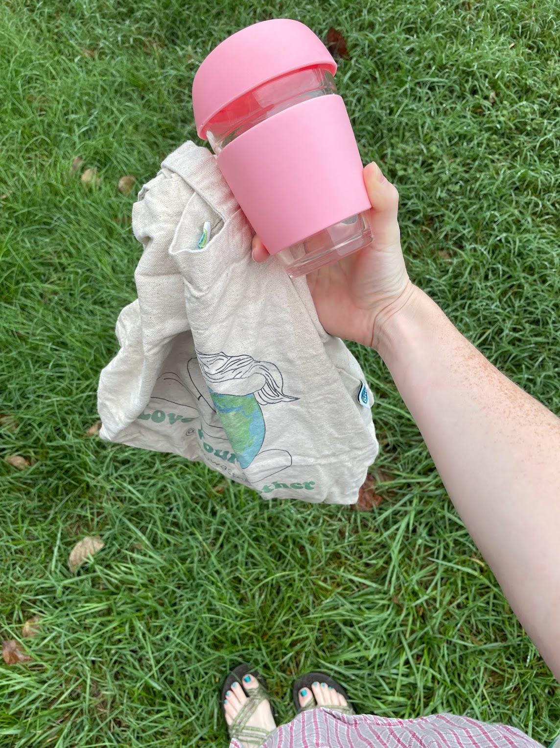 hand holding a reusable cup