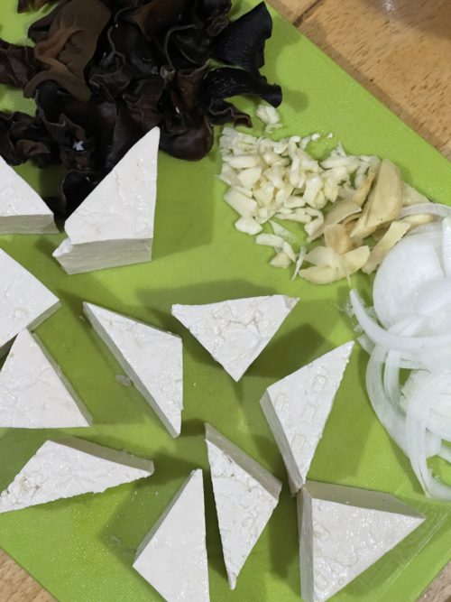 lotus root stir fry ingredients on a green cutting board