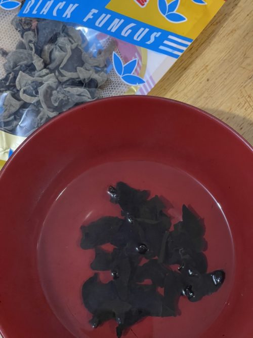 dehydrated black wood fungus; wood fungus in a red bowl