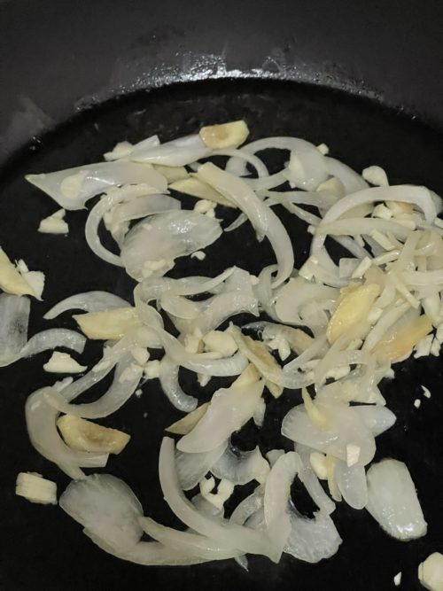 ginger, onion, and garlic in a dark frying pan