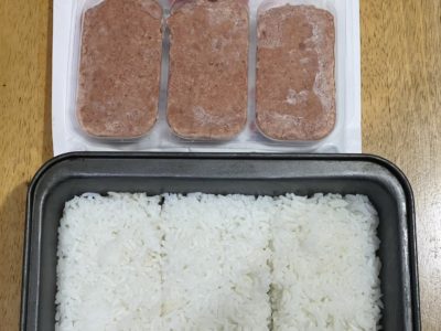 vegan spam and rice on a wooden surface
