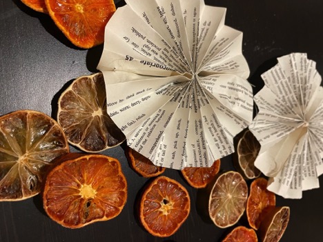 dried oranges and folded dictionary paper ornaments
