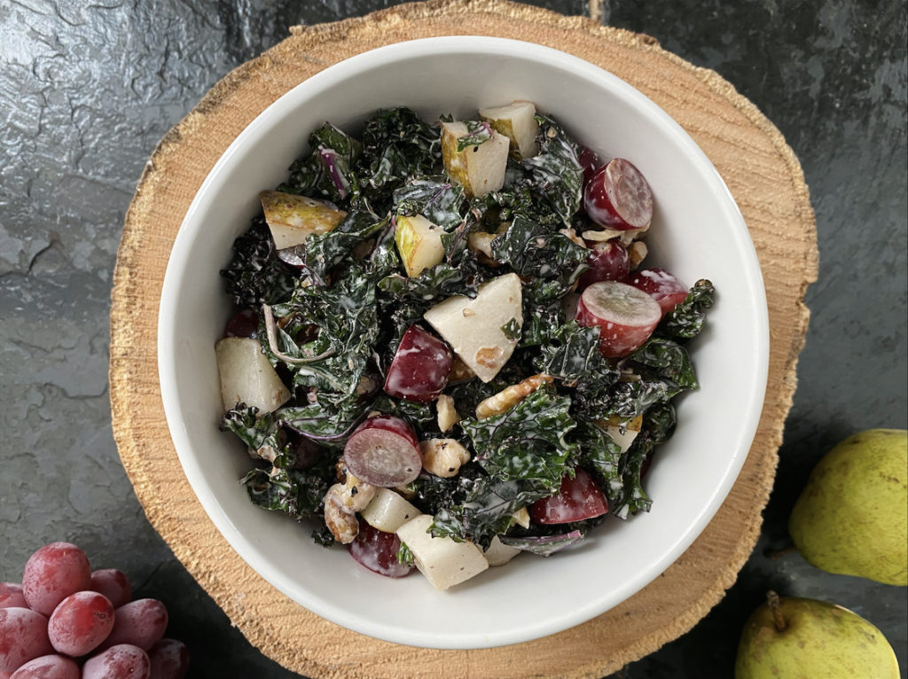 waldorf salad in a white bowl against a black and brown background