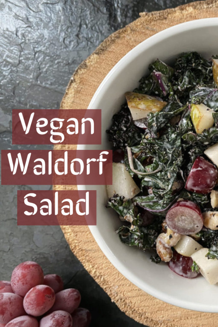 waldorf salad in a white bowl against a black and brown background with caption