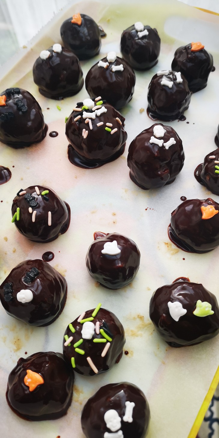 vegan chocolate chestnut balls with halloween sprinkles on a baking tray