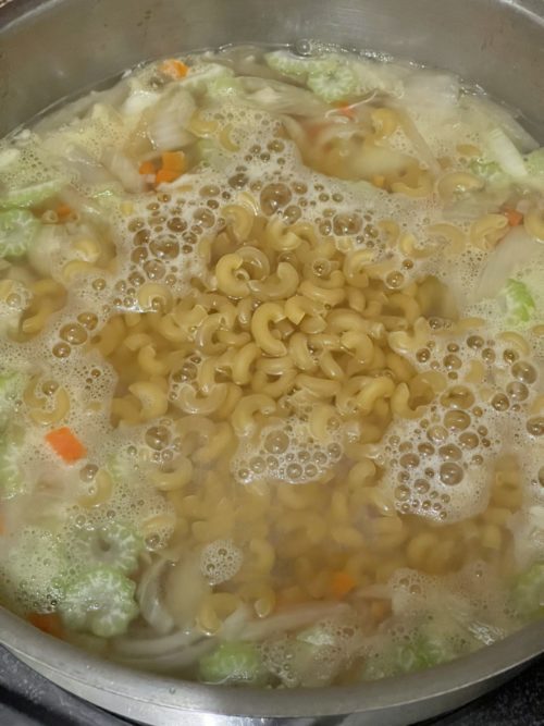 vegan chicken macaroni soup in a silver bowl