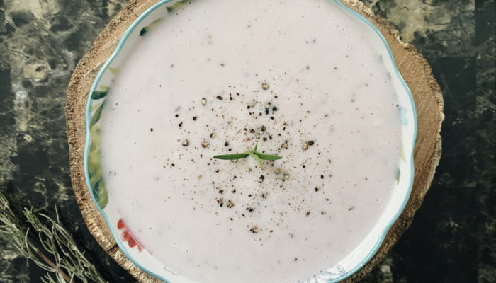 hearts of palm soup in a dish against a dark and light background