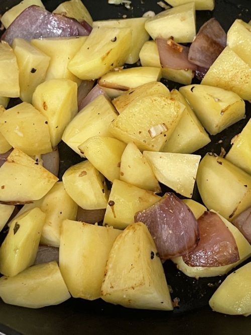 potatoes and purple onions on a dark background