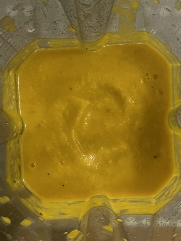 an orange mixture for pumpkin miso soup in a blender