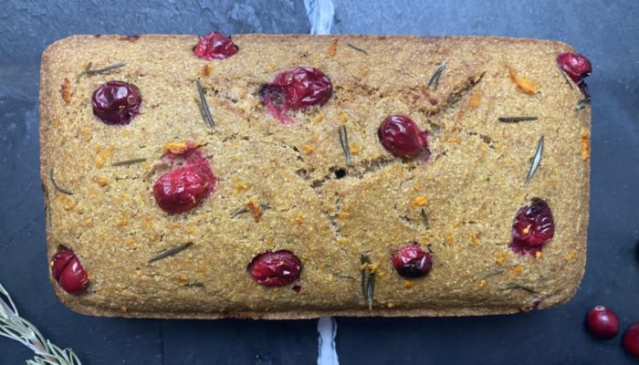 vegan cranberry cornbread against a dark background