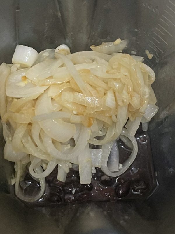 a pile of cooked onions against a dark background