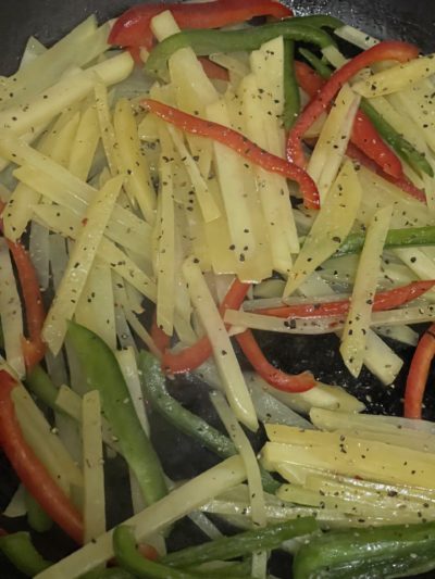 shredded potatoes with red and green bell peppers and seasonings