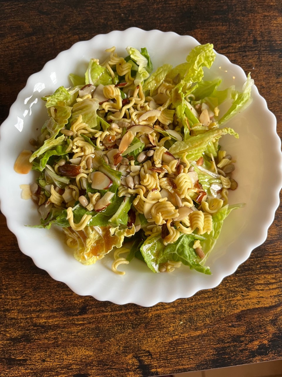 Cabbage salad on a white plate with a brown background