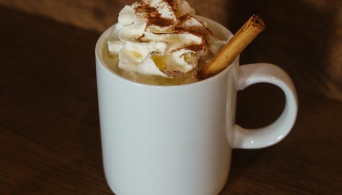vegan eggnog in a white mug with cinnamon
