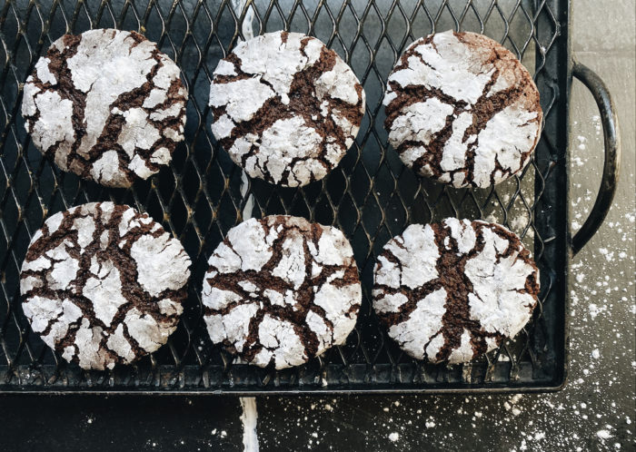 vegan chocolate crinkle cookies on a black cooling rack