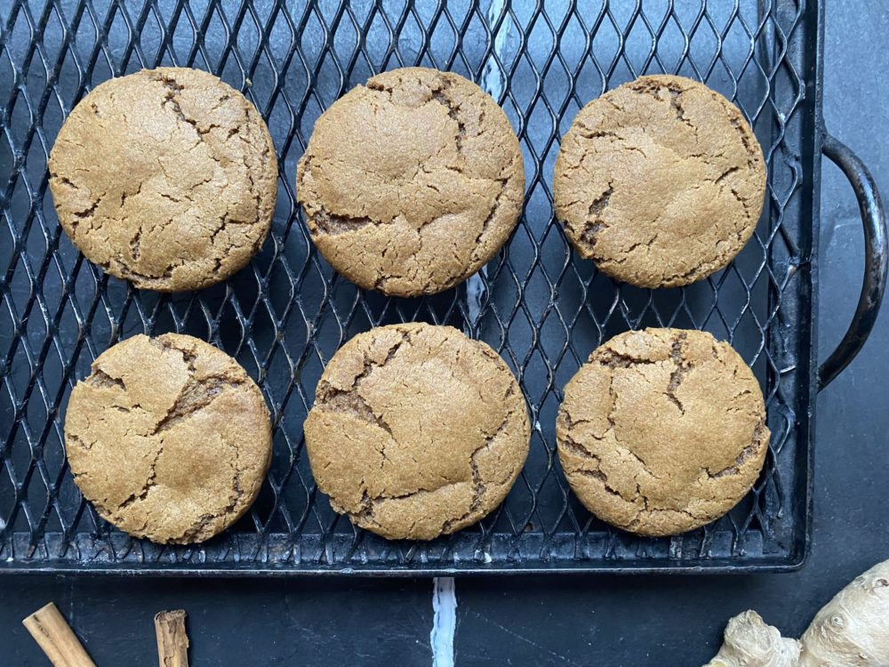 vegan gingerbread cookies on a black cooling rack