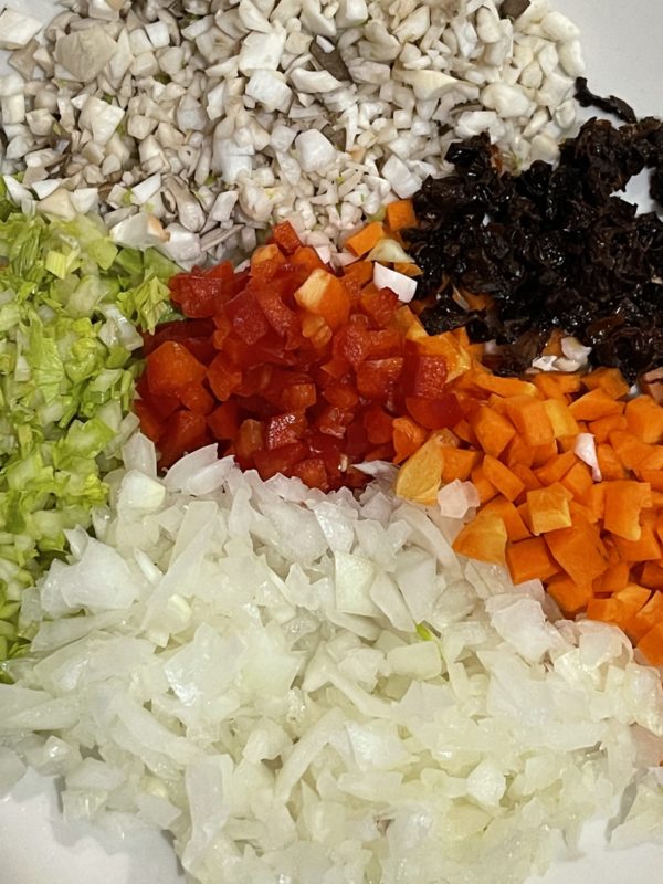 Piles of colorful vegetables against a white background