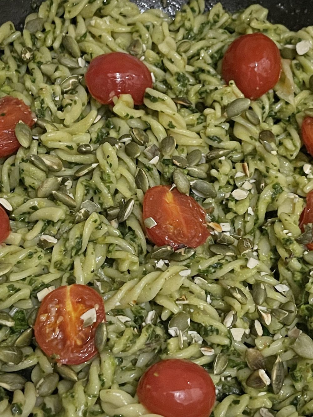 Pasta with halved cherry tomatoes and seasonings