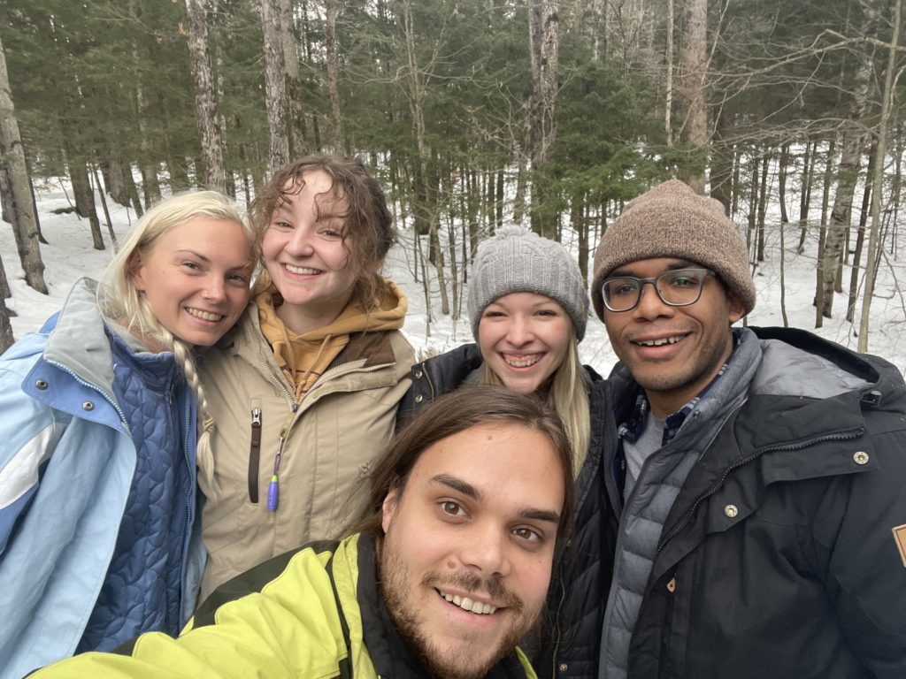group of friends smiling in wintry scene