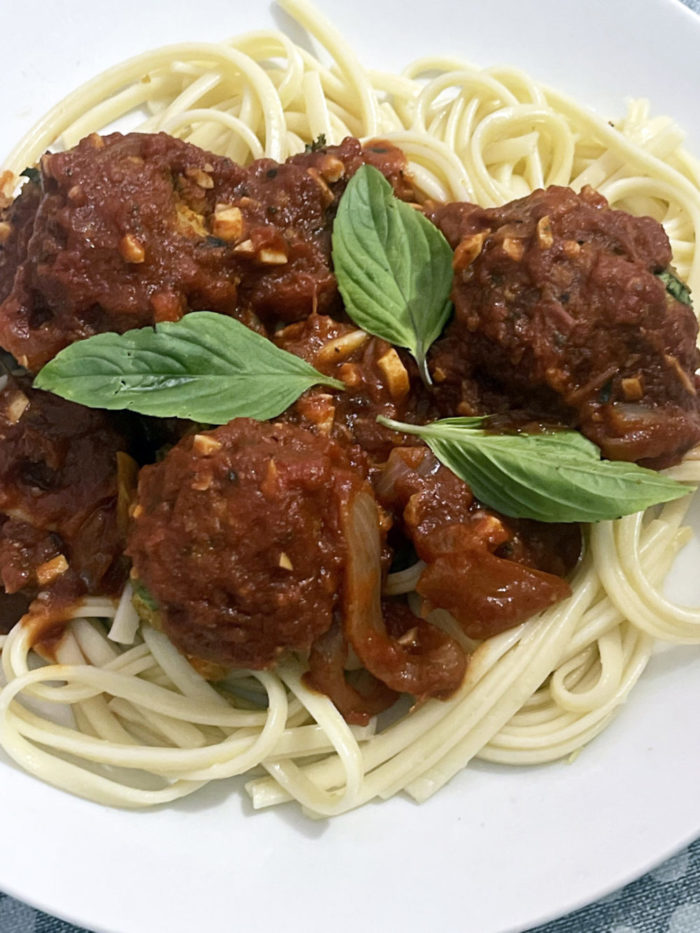 vegan spaghetti and meatballs in a white bowl