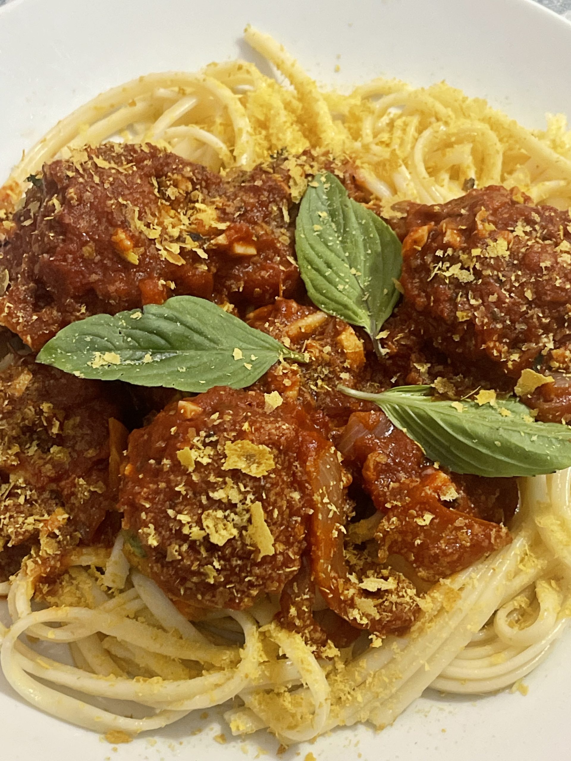 vegan spaghetti and meatballs on a white plate