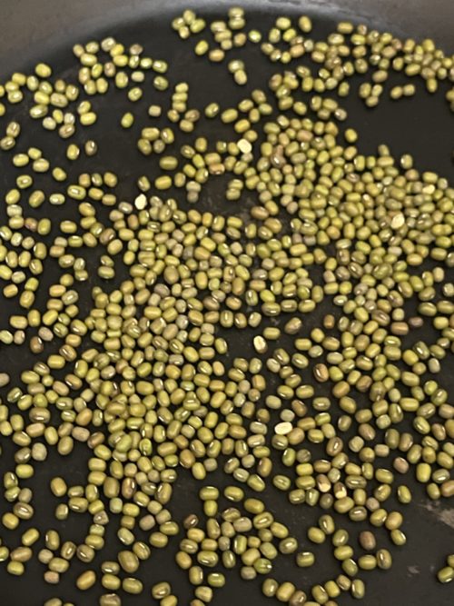 mung beans against a black background