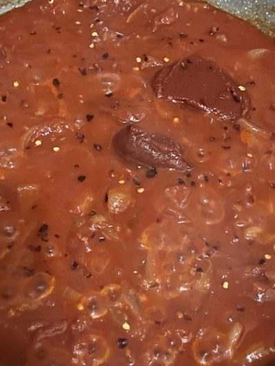 tomato sauce with chili flakes scattered on top.
