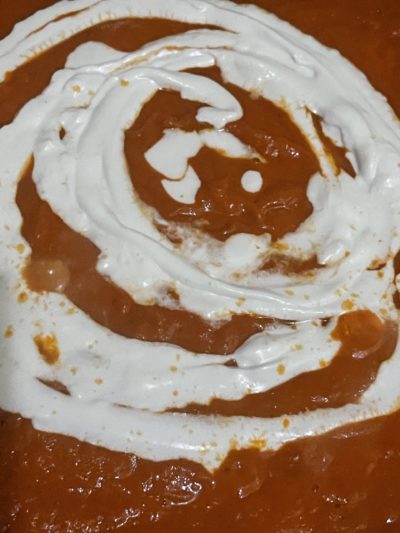 tomato sauce with vegan cream swirled on top.