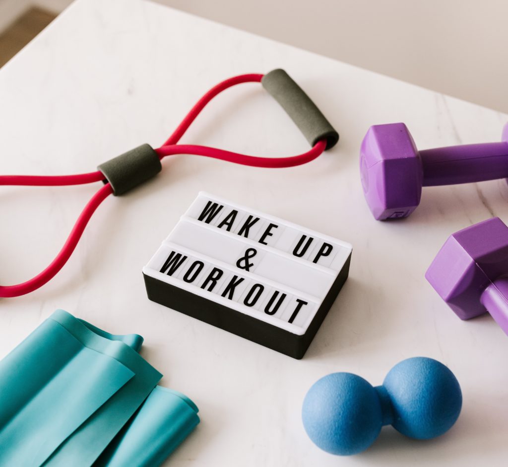 exercise equipment around sign that says wake up and workout