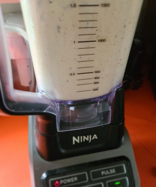 a blender on an orange countertop