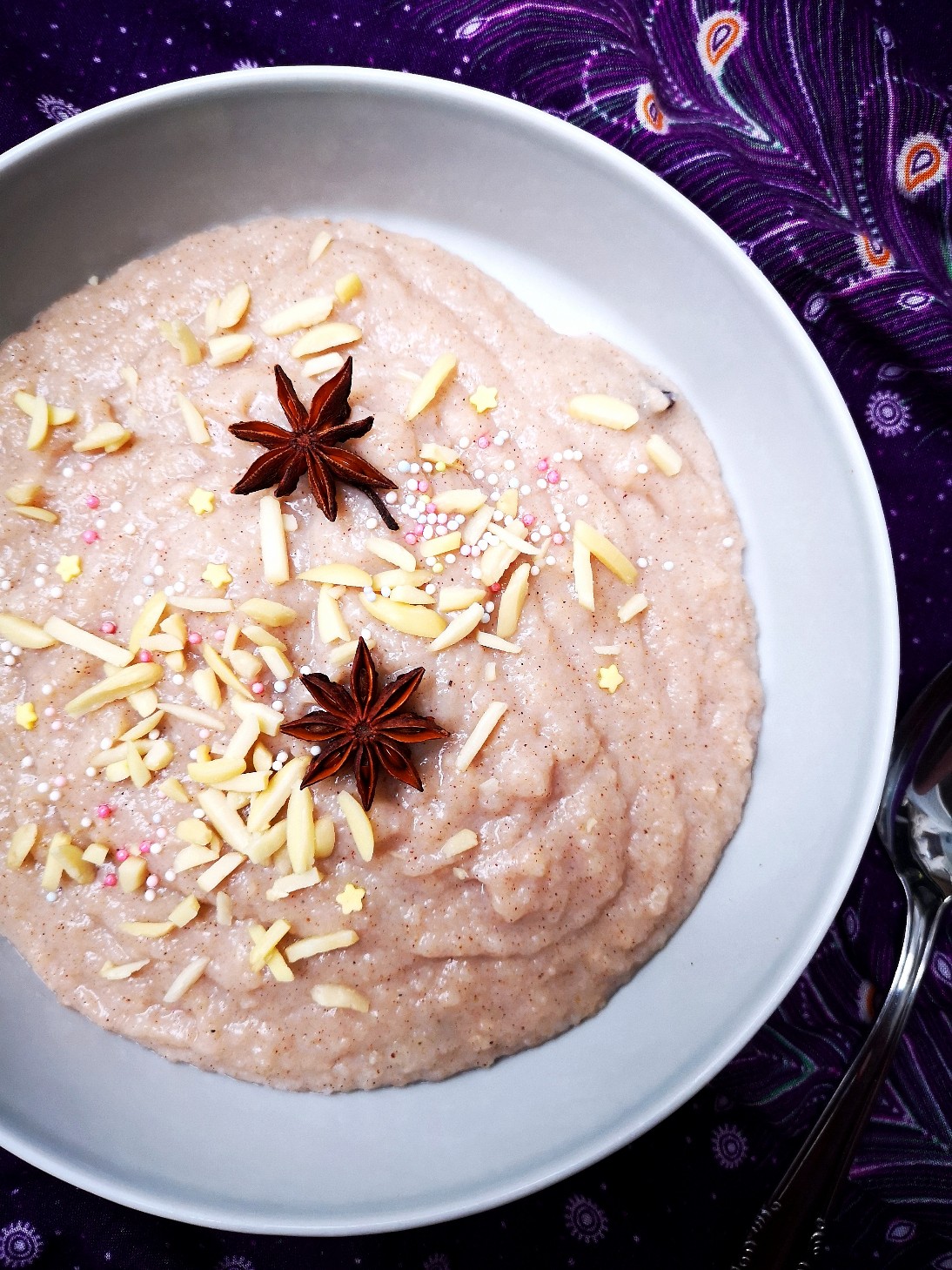 Rice porridge in a white bowl against a decorative purple background