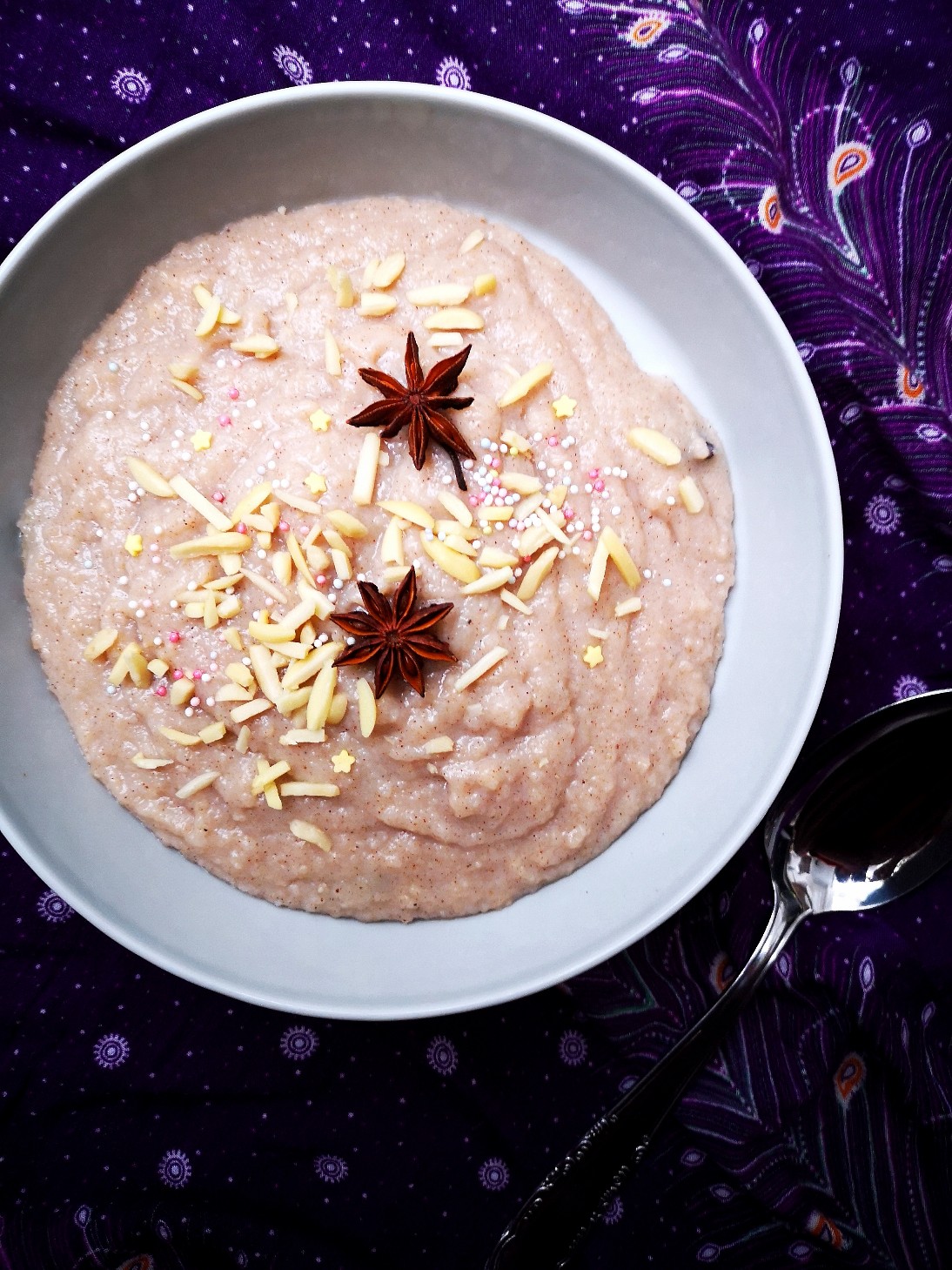 Rice porridge in a white bowl against a decorative purple background