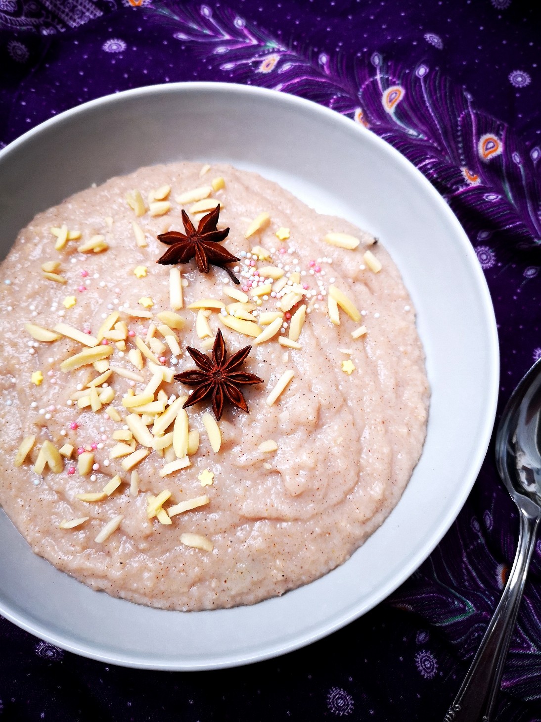 Rice porridge in a white bowl against a decorative purple background