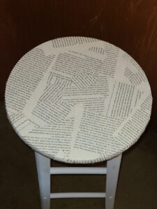 the seat of a stool covered in book pages