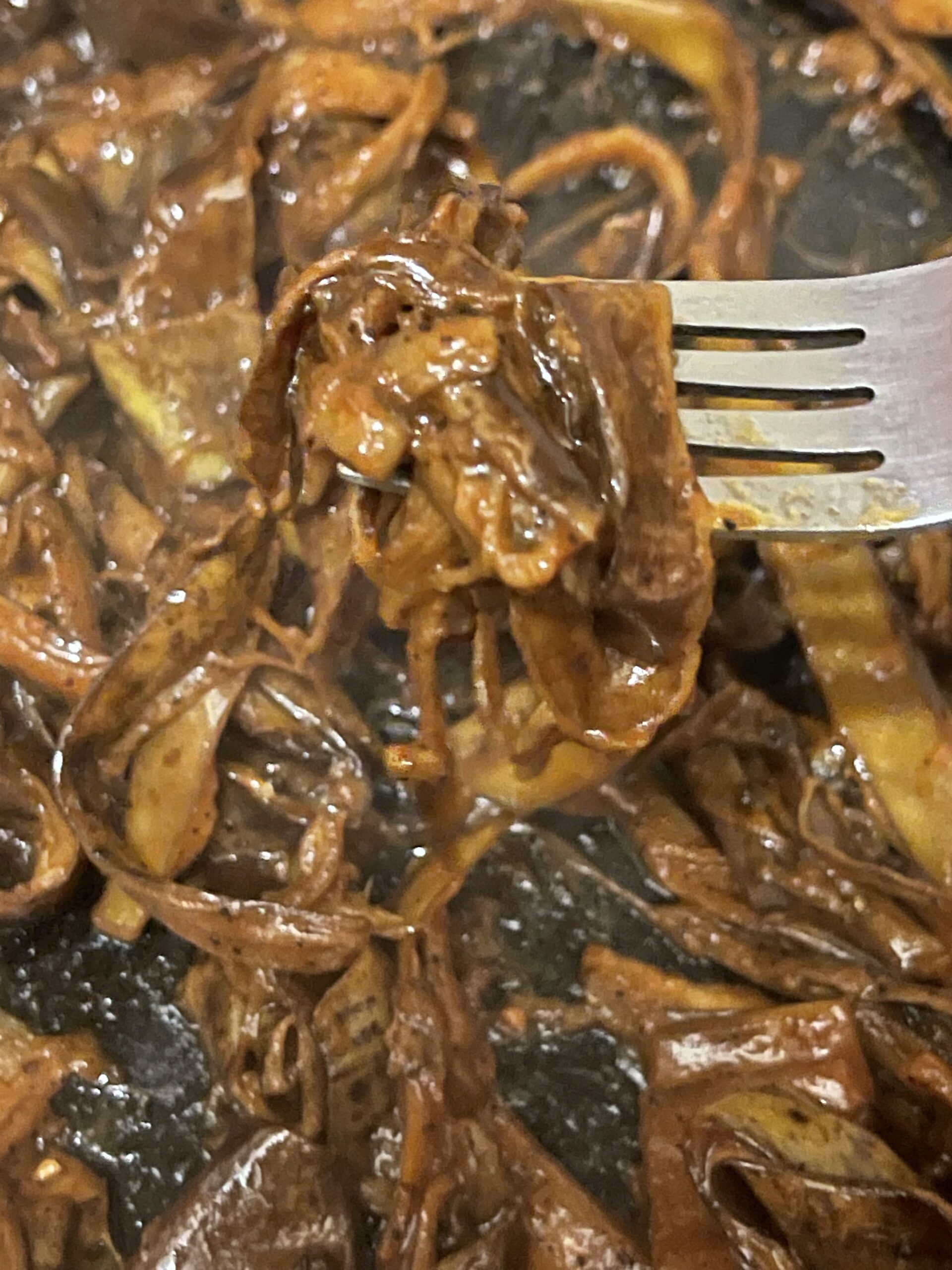 cooked and shredded banana peels in bbq sauce in a pan