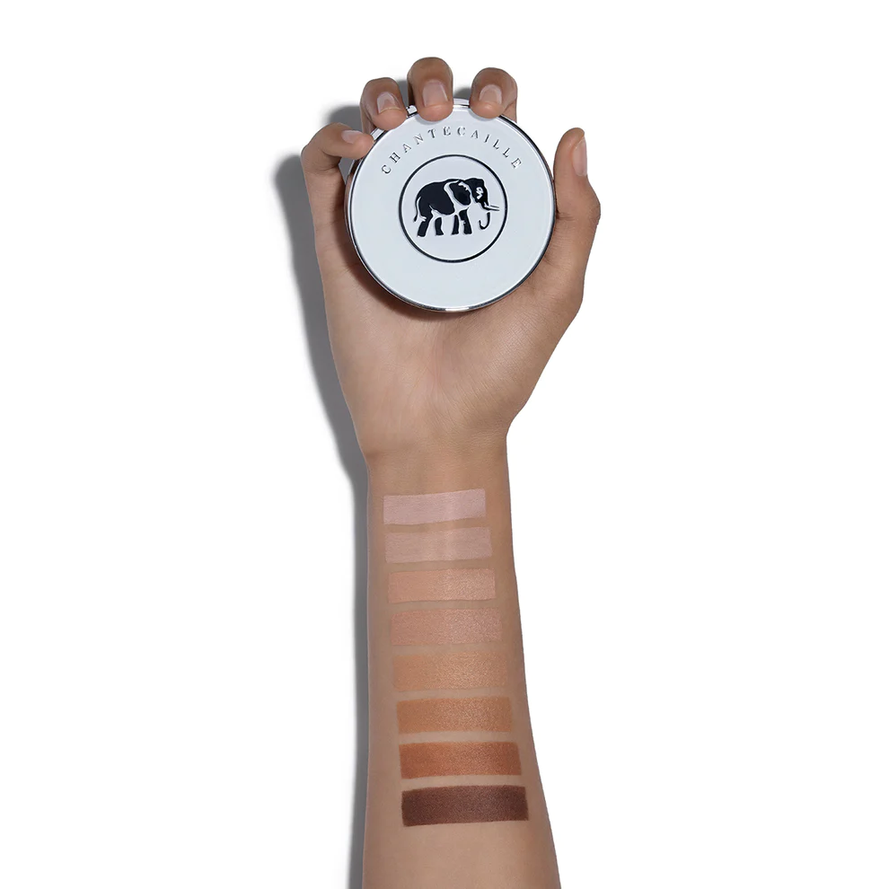 an arm with makeup swatches holding Chantecaille's Future Cushion Foundation against a white background
