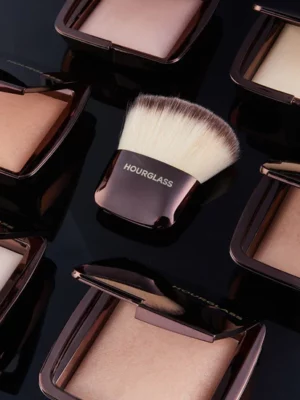 Hourglass' Ambient Lighting Finishing Powders against a black background