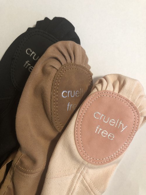 soles of cynthia king vegan ballet flats in pink, brown, and black colorways.