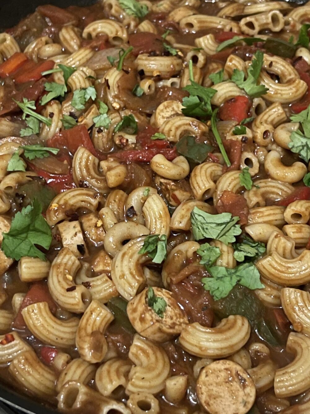 macaroni in the chili sauce and topped with cilantro