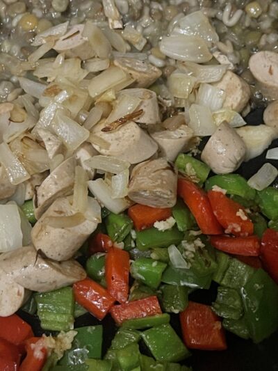 vegan sausage and onions, bell peppers in the pan