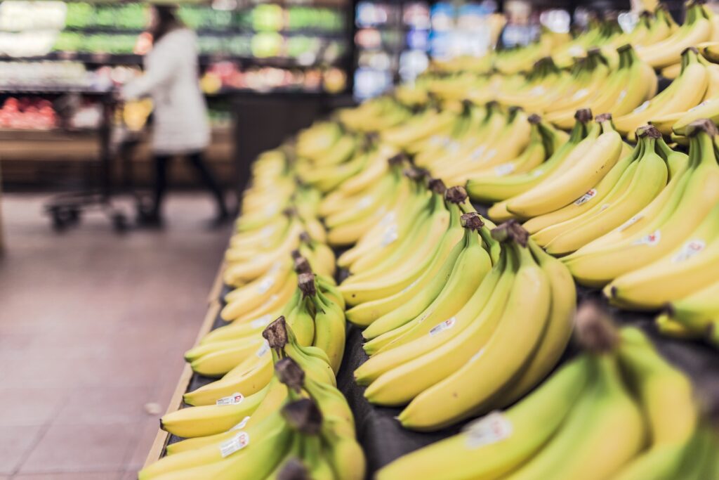 Rows of bananas stocked at supermarket, not likely grown in Hawaii.