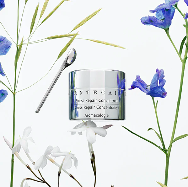 chantecaille stress repair eye cream concentrate against a floral background with blue and white blossoms.