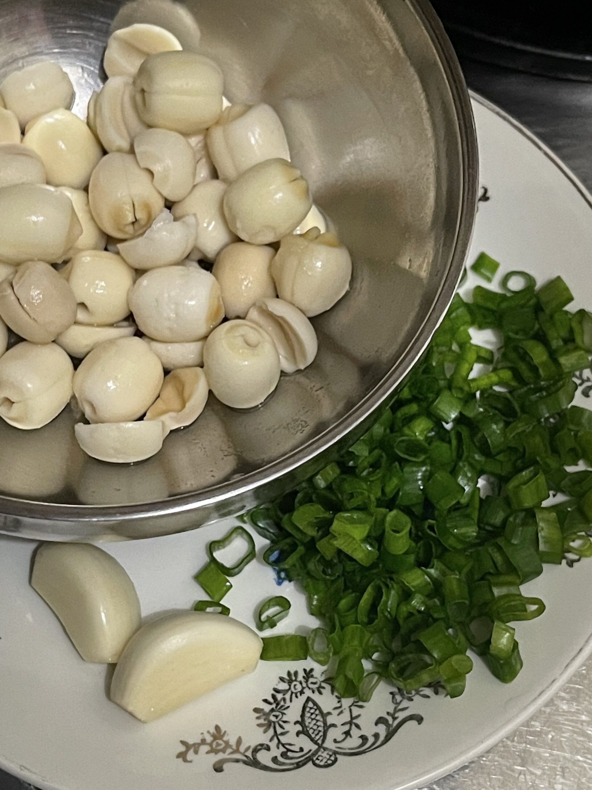 lotus seeds, garlic, and spring onions in a dish