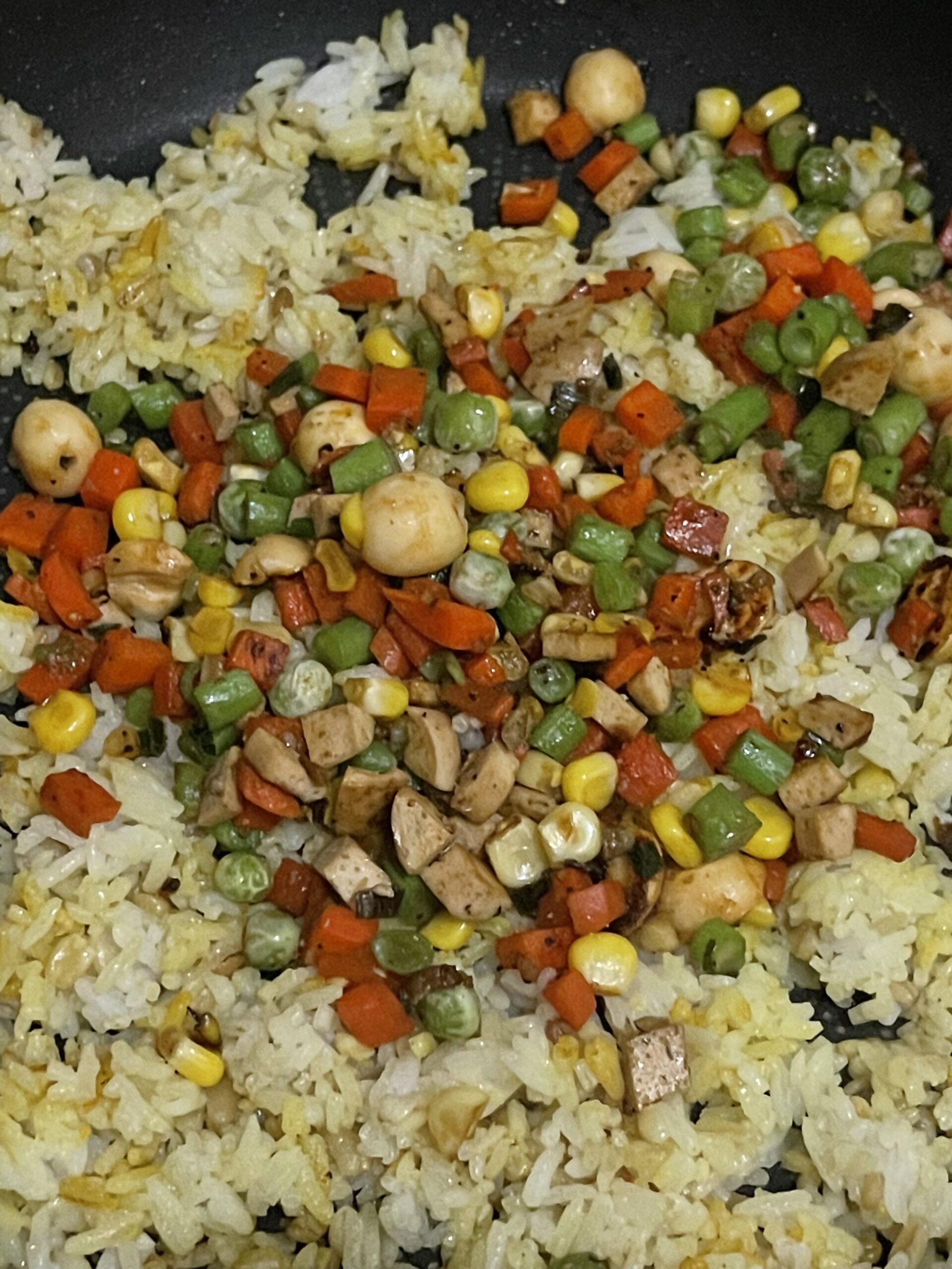 rice with stir fried vegetables added back into the pan.