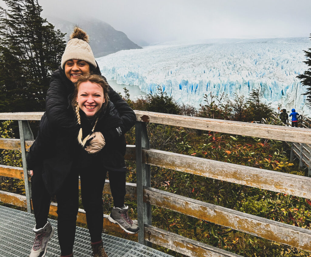 two girls in front of a glacier