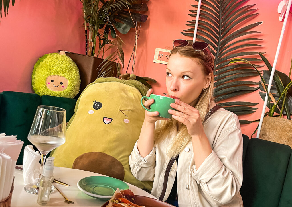 woman sipping coffee at avocado