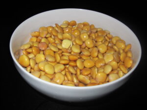 Yellow_Lupini_Beans_In_A_White_Bowl_With_A_Black_Background