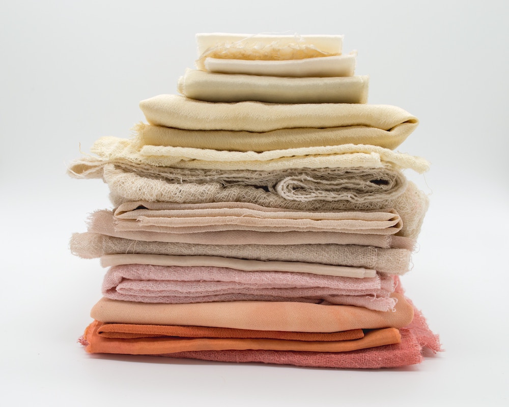 colorful textiles folded and stacked.