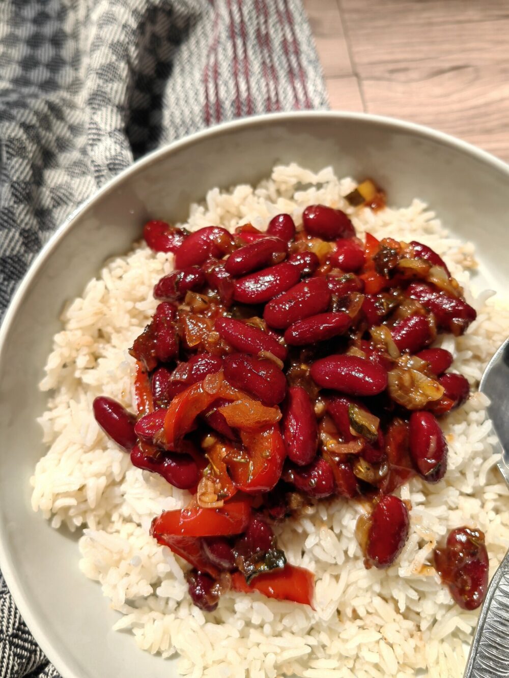 close up of beans over rice in a bowl.