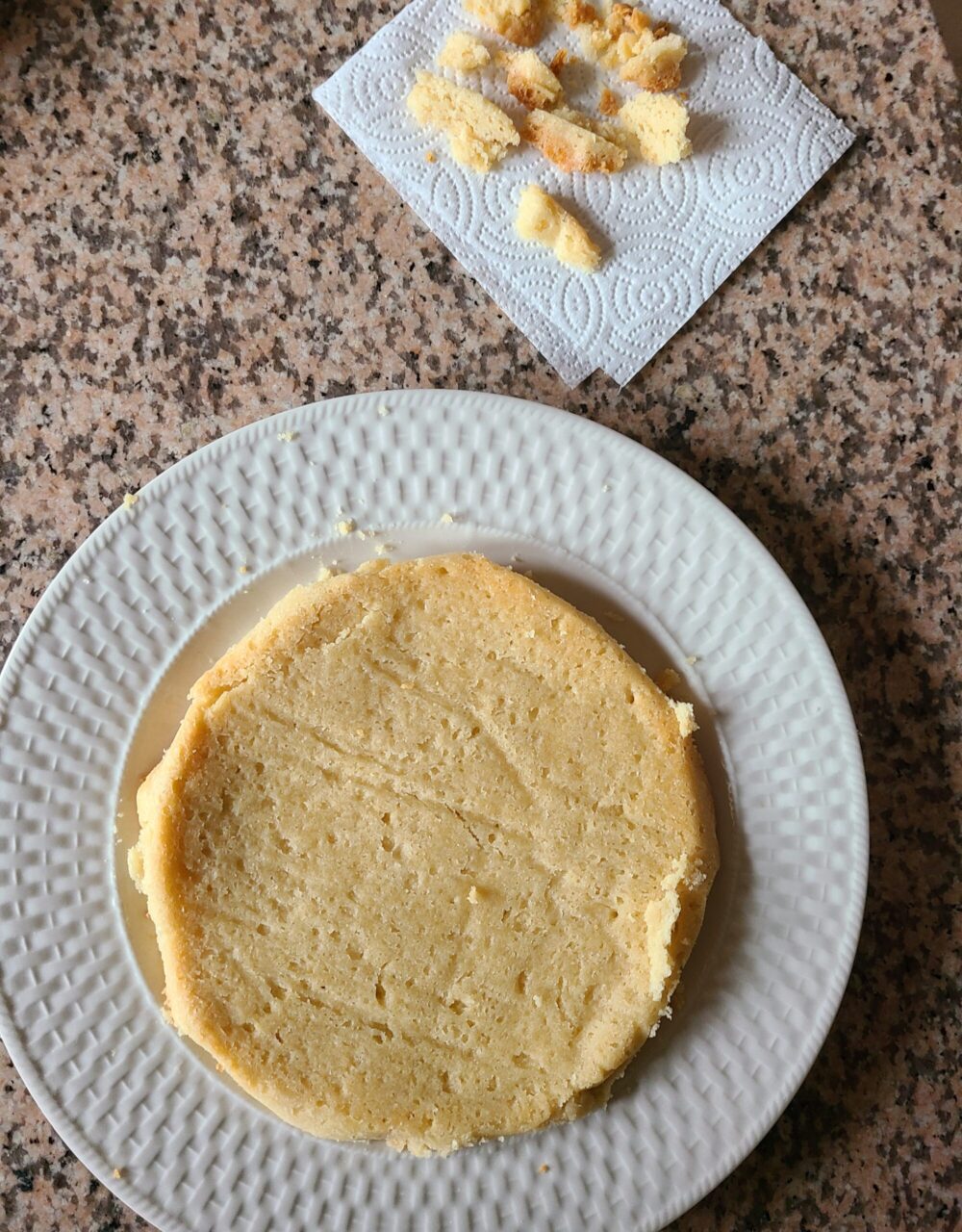 vegan shortbread on a white plate next to cake pieces on a paper towel